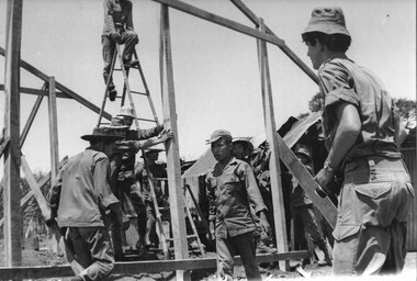 Pte Mike Coyle with the 1st Australian Civil Affairs Unit (1ACA) supervises Ap Sui Nge villagers in the construction of their homes.  