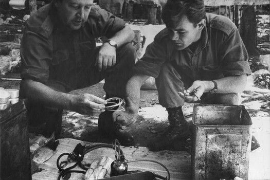 A Doctor from 1st Australian Field Hospital, Vung Tau, advises a 6 RAR/NZ (ANZAC) Intelligence Officer the correct terminology for captures medical supplies. 