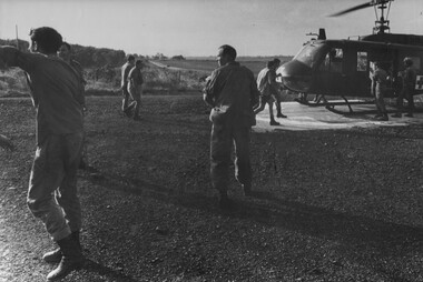 Medics and Intelligence Officers rush to meet and unload an American Dustoff medical evacuation helicopter bring wounded NVA/VIETCONG.