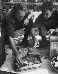 A Doctor from 1st Australian Field Hospital and a 6 RAR/NZ Intelligence Officer inspect captured medical supplies and equipment from the K76A Hospital. 