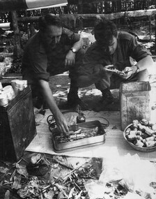 A Doctor from 1st Australian Field Hospital and a 6 RAR/NZ Intelligence Officer inspect captured medical supplies and equipment from the K76A Hospital. 