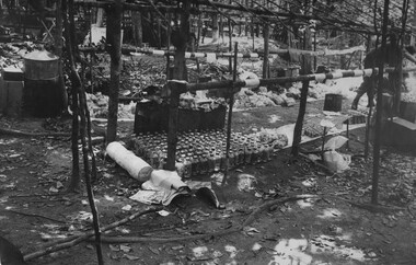 A Doctor from 1st Australian Field Hospital assists the 6 RAR/NZ (ANZAC) Intelligence Officer to check captured medical supplies. 