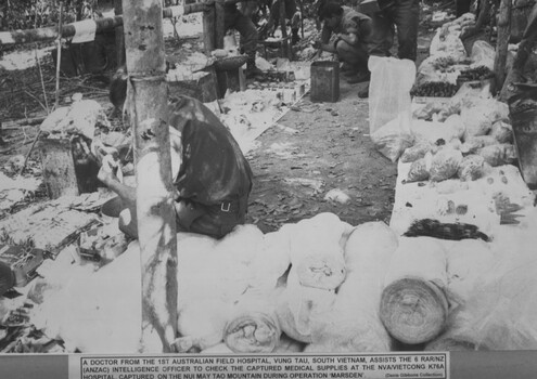 There are several sooldiers checking medical supplies that were captured at the NVA/Vietcong K76A hospital