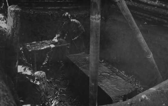 A digger checking out an in ground operating theatre in the K76A hospital.