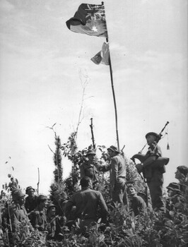 Diggers from 6 RAR (NZ) (ANZAC) raise the Australian flag on the summit of the Nui Tau Mountain.
