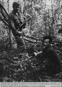 A digger guarding a Vietcong prisoner captured at the NVA Vietcong K76A hospital.