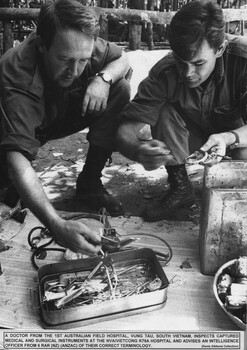 A Doctor from 1st Australian Field Hospital, Vung Tau, South Vietnam, inspects captured medical and surgical instruments at the NVA/VietCong K76A Hospital. 