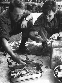 A Doctor from 1st Australian Field Hospital, Vung Tau, South Vietnam, inspects captured medical and surgical instruments at the NVA/VietCong K76A Hospital. 