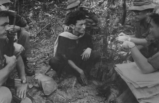 A photograph of a VietCong patient with a South Vietnamese Intellignece Officer, Task Force 6 RAR/NZ (ANZAC)  intellignece.