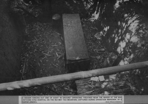 A photograph Digger checking one of eight "in ground" operating theatres near the wards at the NVA/VietCong K76A Hospital.