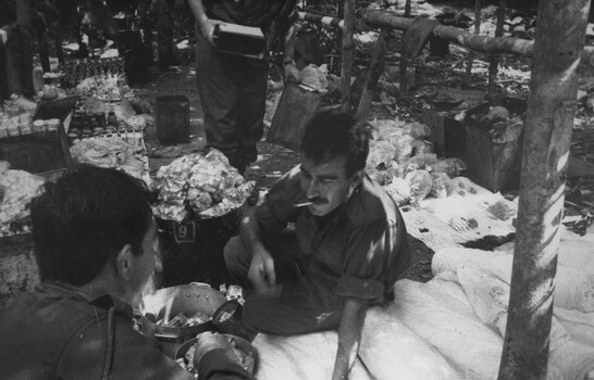 A photograph of a Doctor from 1st Australian Field Hospital, Vung Tau, assists the 6 RAR/NZ (ANZAC) Intelligence Officer during Operation Marsden