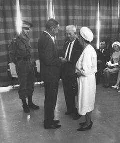 John Gorton presents an emblem of the US Presidential Unit Citation to the parents of one of the Diggers who paid the supreme sacrifice.