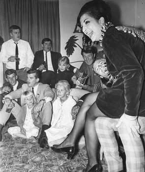 A photograph in Townsville,  18/08/1968, with Rock and Roll stars Little Pattie and Col Joye entertain in the lounge room of a private home. 
