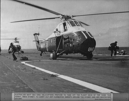 A photograph of Australian Navy Sea King Wessex helicopters prepare to take off the flight deck of the "Vung Tau Ferry" HMAS Sydney.