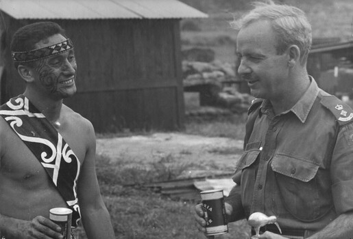 A photograph of the C. O of 9 RAR, Lt Col Morrison,  has a cold beer with a Maori from the  N. Z. 