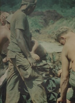 A photograph of G.I. Gunners of A Battery 2/35th US Artillery unpack supplies deliverd by a CH47 Chinook at an Australian Fire Support Base.
