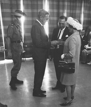 A photograph in Townsville 8/08/1968. The P. M. John Gorton presents an emblem of the U.S.Presidential Unit Citation to next of kins.