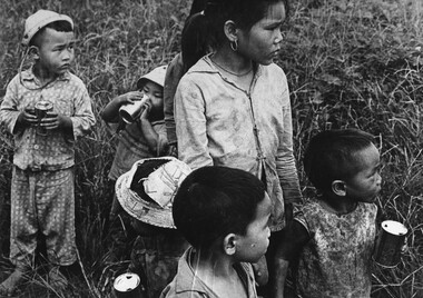 A photograph of Vietnamese Children at Xuyen Moc look apprehensively towards some of their friends.