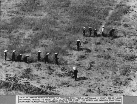 A photograph of  a local Vietnamese women of Phuoc Tuy, seen froma 161 (Indep) Recce Flight helicopter tending to their local village rice fields.  