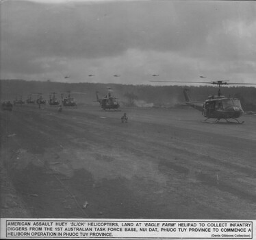 A photograph of an American assault Huey "slick" Helicopters, land at Eagle Farm helipad to collect Infantry Diggers from 1st Australian Task Force Base. 