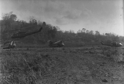 A photograph of Uinited States Army Chinook medium helicopters wait on Kanga pad at 1 ATF Base Nui Dat. 