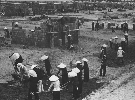A photograph of Vietnamese refugees women from North Vietnam, constructing a refugee village at Tuy Hoa, in 2 Corps, of South Vietnam. 