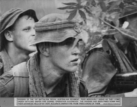 A photograph of Diggers of the 1st Battalion, Royal Australian Regiment, peer nervously ahead as they come under NVA/VC sniper fire during Operation Goodwood. 