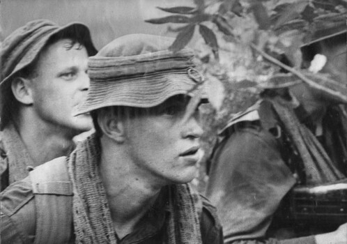 A photograph of Diggers of the 1st Battalion, Royal Australian Regiment, peer nervously ahead as they come under NVA/VC sniper fire during Operation Goodwood. 