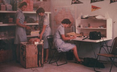 A photograph of 8 Field Ambulance, Red Cross girls Janice Webb, Winsome Ayliffe and Jean Debelle, unpack store supplies sent from Australia. 