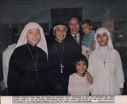 A photograph of Johnny O'Keefe took time out from his concert program to vist the orphans and their caring nuns at the An Phong Orphanage.
