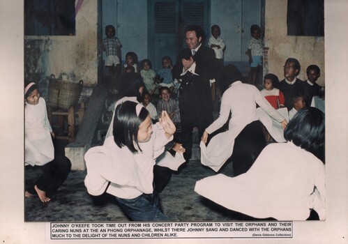 A photograhp of Johnny O'Keefe visting the orphans and their caring nuns at the An Phong Orphanage, who sang and danced with the orphans.