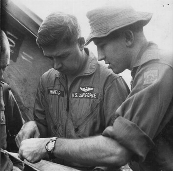 A photograph of Lt Colin Scott DFC, shows Capt Dick Niemela an American Forward Air Controller, the area coordinates, of a large NVA/VietCong force.