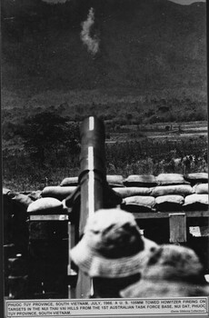 A photograph at Phuoc Tuy Province, July 1966. A US 105mm towed Howitzer firing on targets in the Nui Thai Vai hills. 