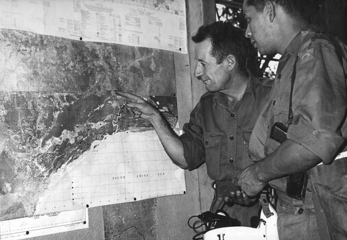 2Lt Tom 'Rockets' Guivarra Mid, a fixed wing pilot with 161 (Indep) Recce Flt receives a mission brief from Bombadier Allan 'Bomber' Harris DFC.