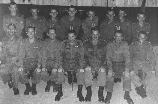 A black and white photograph of 161 (Indep) Recce flight Officers, in a playful mood.