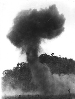 A pallet load of 105mm artillery amunition explodes on impact with the ground after being dropped from an RAAF 35 Squadron Caribou aircraft. 
