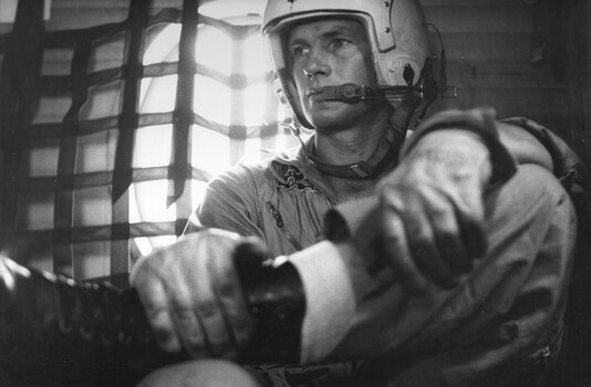 Crew Chief, Cpl Allan Hudson, of an RAAF No 35 Squadron Caribou at his post in the front of the plane. 