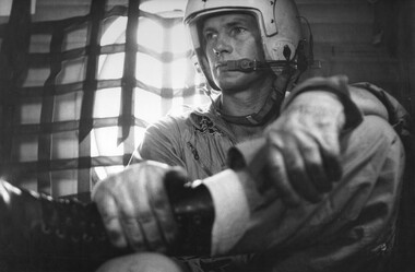 Crew Chief, Cpl Allan Hudson, of an RAAF No 35 Squadron Caribou at his post in the front of the plane. 
