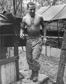 2Lt Tom 'Rockets' Guivarra, a fixed wing pilot with 161 (Indep) Recce Flight stamps down sandbags. 