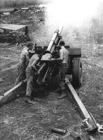 Gunners of 104 Battery RAA at Fire Base "Betty" firing on a high angle against NVA/VietCong sappers.