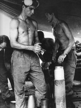 Gnr Mike Longley and Gnf Charlie Hayden, 104 Battery Royal Australian Artillery, at Fire Base Betty in the ammunition bunker preparing shells for firing. 