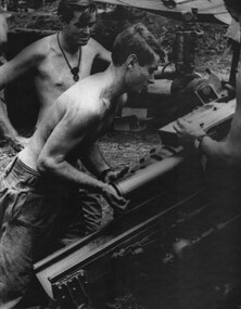 Gnr Alan Muston rams a shell home watched by Gnr Dave Thomas 104 Battery Royal Australian Artillery, at Fire Base Betty. 