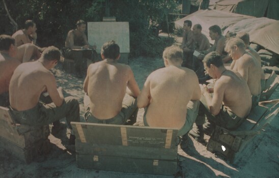 Gunners of 104 Battery Royal Australian Artillary, at Fire Support Base Betty attend the nightly situation report and orders.  