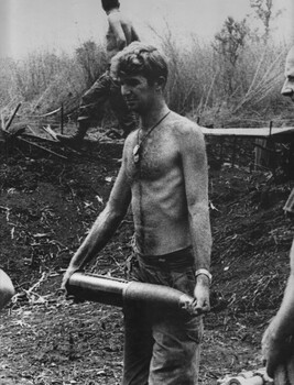 Gnr Jim Dunn, 104 Battery Royal Australian Artillery, carries a 105mm shell to the gun at Fire Support Base "Betty". 