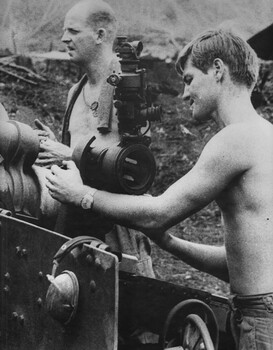 104 Battery RAA, Gnr Leo Adams, adjust the sight of the 105mm gun while Sgt Peter Tilbrook contemplates the fire mission. 