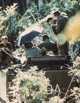 An APC of B Squadron appears to be swallowed up by the vegetation as it is parked during a lull in operations. 