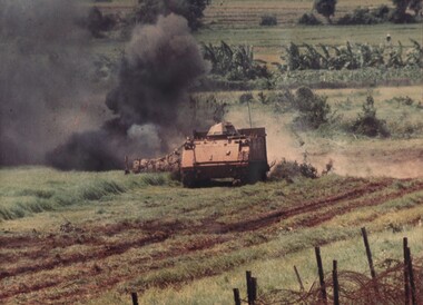 A specially constructed 'up armoured' APC being used to explode anti personnel mines buried in the 'Barrier' minefield from the village of Dat Do.