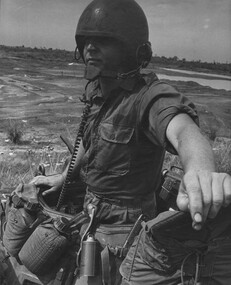 Cpl Normie Rowe peers pensively from the turret of his Armoured Personnel Carrier.