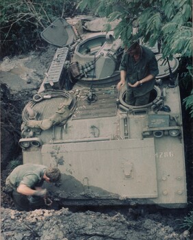 Cpl Normie Rowe digs out his APC. Normie had ordered his driver to proceed down the hill. 