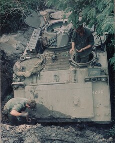 Cpl Normie Rowe digs out his APC. Normie had ordered his driver to proceed down the hill. 